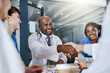 © peopleimages.com - Team, meeting or doctor with handshake in office for policy agreement, hospital planning or efficiency. Collaboration, communication or people shaking hands for deal, partnership or care optimization