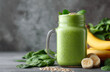 © aboutnuylove - Healthy green smoothie with spinach, banana and oatmeal on grey background