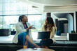 © Jacob Lund - Female coworkers engaging in a productive discussion at the office