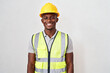 © Jane - A construction worker wearing a yellow hard hat and high-visibility vest smiles at the camera against a plain background.