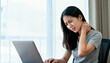 © NanieStudio - Asian woman with neck pain from computer work. Office syndrome concept. Stiff muscle ache, health problem, poor posture, ergonomic pain, burnout, and fatigue from remote work.