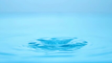 Wall Mural - A serene slow motion water splash captured as delicate spray rises and falls into a pristine clear pool, emphasizing purity and calm nature, tranquil, advertising