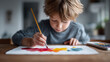 © SolaruS - Creative child engrossed in watercolor painting. Focus on art education, childhood development, and imaginative expression. Evokes joy and creativity.