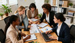 © Jane - A multiethnic group of female professionals in a strategic meeting. Businesswomen collaborating, analyzing financial data, charts on laptops and paper for corporate planning.