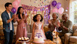 © Jane - Happy multiethnic family celebrating a little girl's 6th birthday party at home. Three generations, parents and grandparents, clapping with joy as confetti falls. A cute dog joins.