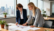 © Jane - Two professional businesswomen collaborating in modern office discussing documents and analyzing data charts during teamwork meeting with city skyline view in background