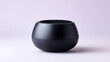 © Supot - Sleek wireless speaker black bowl shape minimalist design modern audio device studio shot white seamless soft light matte finish portable clean aesthetic. Calm refined contemporary vibe