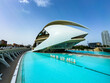 Marvel at the stunning architecture of the Palau de Les Arts in Valencia during a clear blue sky afternoon