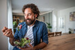 © Migma_Agency - Happy man enjoying fresh healthy salad for lunch