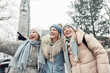 © Kyryl Gorlov - Three cheerful young adult women friend walk Magdeburg street old european uk german town city street enjoy having fun laughing cold winter day together. Female persons friendship celebration weekend