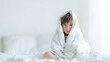 © Frenza - Sad british american Male child 6 years old wrapped in blanket sitting on bed