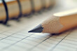 © fatih - Close-up of a pencil on a notebook with a grid, illustrating the concept of writing and studying