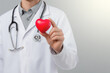 © Frank Parker - Doctor holding red heart symbol with stethoscope in medical setting