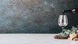 © pvl0707 - Pouring red wine into a glass with wooden corks and greenery on a light surface against a textured background