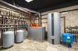 © alhim - A well-organized boiler room features modern heating equipment, including storage tanks and piping systems. This setup ensures energy efficiency and reliable heating for the building