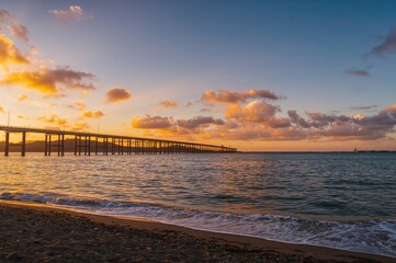 Wall Mural - sunset over a span of water
