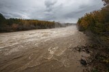 Heavy Rain Triggers Floods and Landslides. Turbid Water Rushes Through Overflowing River. Intense River Current View.