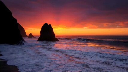 Wall Mural - dramatic sunset coastal waves timelapse, colorful sky reflecting on the powerful ocean and rock form