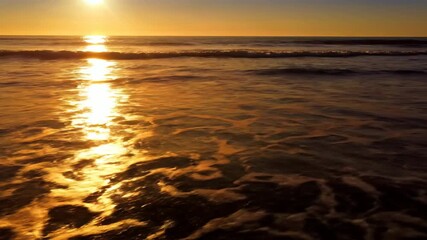 Wall Mural - Dazzling timelapse of golden sunlight dancing and glinting across the surface of gentle ocean waves, creating a mesmerizing pattern of light sun, commercial, tranquil