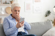 © Prostock-studio - Coronavirus News. Shocked Senior Woman Reading Information On Smartphone At Home, Afraid Of Covid-19 Statistics, Free Space