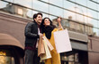 © Prostock-studio - Beautiful couple shopping together in the city, walking with paper bags