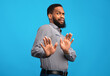 © Prostock-studio - Ew, It's So Gross. Young african man with disgusted expression repulsing something, saying please stop, blue wall