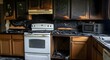 © Bhavesh - Damaged kitchen interior after fire accident with burnt cabinets, charred walls, and destroyed appliances, concept of home disaster, safety, and insurance