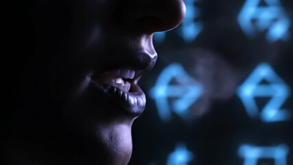 Close-up profile of a person in a dark room with blue screens in the background, 4k resolution.