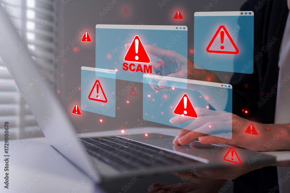 Adult professional encountering multiple scam alerts on laptop during ...
