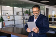 © fizkes - Businessman looks at tablet with joyful expression