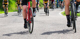 wheels of racing bikes as cyclists climb a steep mountain pass during a road race