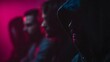 © Thares2020 - Mysterious group of men in hoodies silhouetted against vibrant neon light in a dark atmospheric room conveying focus and intensity
