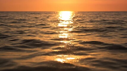 Wall Mural - Dazzling timelapse of golden sunlight dancing and glinting across the surface of gentle ocean waves, creating a mesmerizing pattern of light calm, energy, warmth