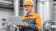 © 69 - Skilled male engineer in safety helmet using laptop in industrial setting, focused on project management and productivity in manufacturing environment