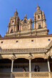 Salamanca University with its historic facade and ornate Plateresque architecture under a bright sky in Salamanca, Spain