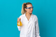 © luismolinero - Young scientific woman isolated on blue background looking to the side