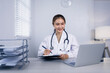 © SOMKID - Medical professional using a computer for online patient support, Medical professional and Healthcare technology Concept.