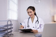 © SOMKID - Medical professional using a computer for online patient support, Medical professional and Healthcare technology Concept.
