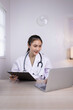 © SOMKID - Medical professional using a computer for online patient support, Medical professional and Healthcare technology Concept.
