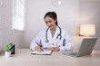 © SOMKID - Medical professional using a computer for online patient support, Medical professional and Healthcare technology Concept.