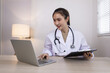 © SOMKID - Medical professional using a computer for online patient support, Medical professional and Healthcare technology Concept.