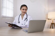 © SOMKID - Medical professional using a computer for online patient support, Medical professional and Healthcare technology Concept.