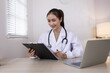 © SOMKID - Medical professional using a computer for online patient support, Medical professional and Healthcare technology Concept.