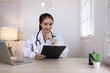 © SOMKID - Medical professional using a computer for online patient support, Medical professional and Healthcare technology Concept.