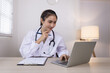 © SOMKID - Medical professional using a computer for online patient support, Medical professional and Healthcare technology Concept.