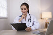 © SOMKID - Medical professional using a computer for online patient support, Medical professional and Healthcare technology Concept.