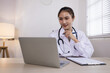 © SOMKID - Medical professional using a computer for online patient support, Medical professional and Healthcare technology Concept.