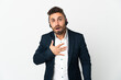 © luismolinero - Telemarketer man working with a headset isolated on white background surprised and shocked while looking right