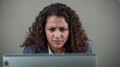 © AImageZ - Woman upset reading work email while focused on laptop screen