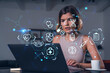 © VideoFlow - Woman using laptop with futuristic medical interface concept icons displayed in hexagons over modern background in soft indoor setting..